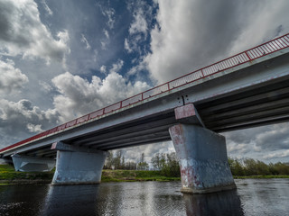 Road bridge over the river under a stormy sky. The road that goes over the horizon.   © vitaly
