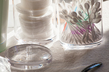 Cotton pads and cotton ear buds, the health care supplies in a bathroom 