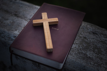 Crucifix and bible The Tripitaka Christian education concept that is open and praying to God, faith...