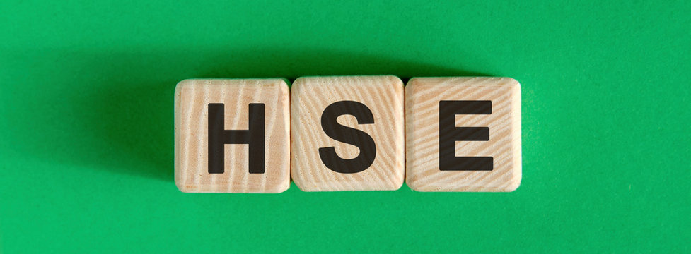 HSE - text on wooden cubes with green background