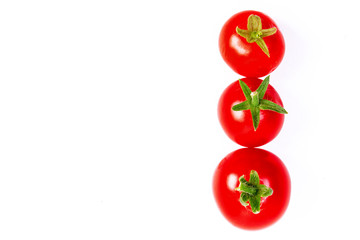 three red cherry tomatoes on a white background