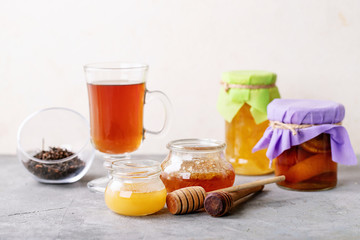 Glass cup of black tea served with honey
