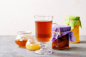 Glass cup of black tea served with honey