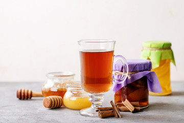 Glass cup of black tea served with honey