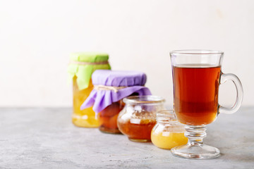 Glass cup of black tea served with honey