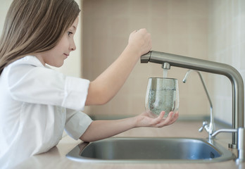 Filling cup beverage. Pouring fresh drink into a glass. Hydration. Healthy lifestyle. Water is preserving your health. Protecting the environment - tap water more environmentally friendly than bottled