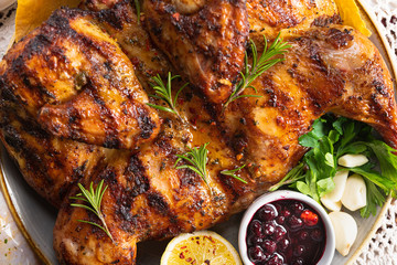 Juicy grilled tobacco chickens with rosemary, lemon, garlic