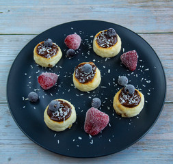 Cheesecakes with bitter chocolate and different berries