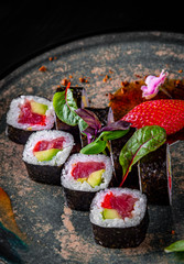 sushi roll with tuna, avocado, rice in plate