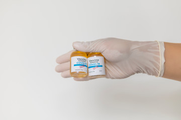 Doctor hand holding vial with medication, closeup. Vaccination and immunization