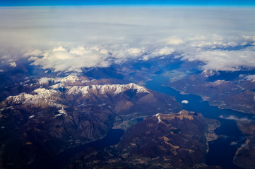 Como Lake between Italy and Switzerland view from an airplane with clouds and blue sky