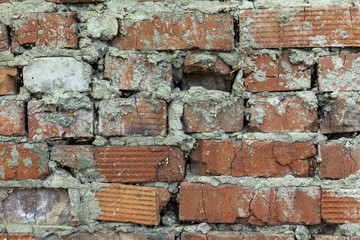 Fragment of an old red brick wall