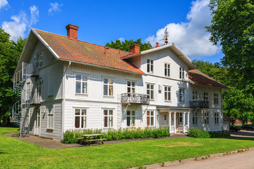 Old white wooden house in a public park
