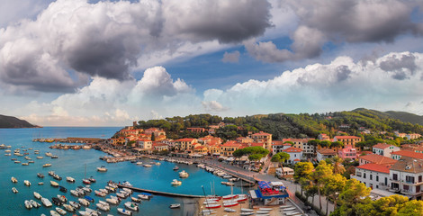 Fototapeta premium Aerila view of Marina di Campo coastline at sunset, Elba Island - Italy