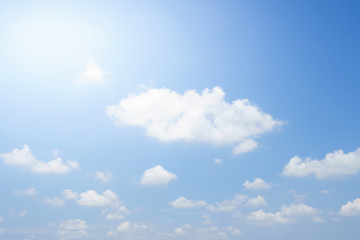 The sky is bright blue. There are clouds floating through. Feel relax when looking. See the sun on the sun.