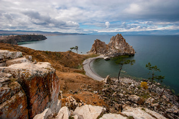 The sacred rock Shaman on the island of Olkhon on Lake Baikal. Big stones in the foreground. The...