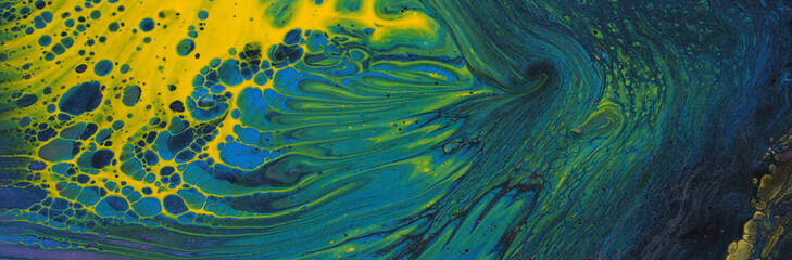 art photography of abstract marbleized effect background. Black, yellow, green and blue creative...
