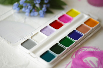 palette with paints, different colors, brush drawing
