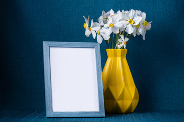 Beautiful narcissus flowers in yellow scandinavian style vase