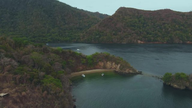 Ascending aerial of Anse Paoua Bay which is only reached by boat from the Caribean island of Trinidad