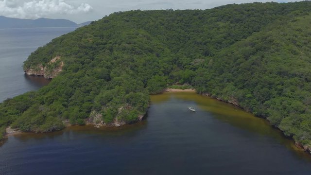 Drone view of a yacht anchored at Perruquier bay just seven miles from the coast of Venezuela on the Caribbean island of Chacachacare