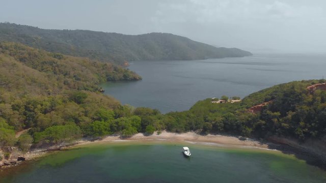 La Tinta bay on the tiny island of Chacachacare with a yacht anchored on its secluded shoreline
