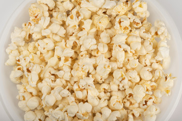Popcorn in white plate on white background