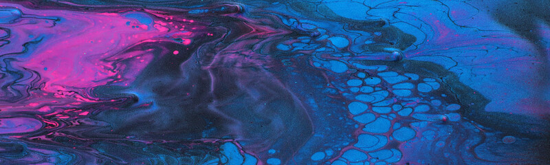 art photography of abstract marbleized effect background. Black, blue, pink and purple creative colors. Beautiful paint