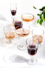 Rose wine in glasses standing on the white table served for a summer party
