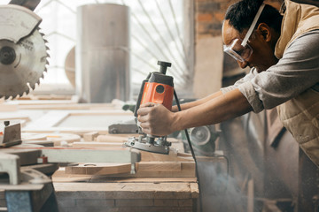 Carpenter working of manual milling machine in the carpentry