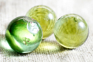 Industrial glass marble damaged, imperfect, used worn shattered chipped character. Bottle green group of 3.