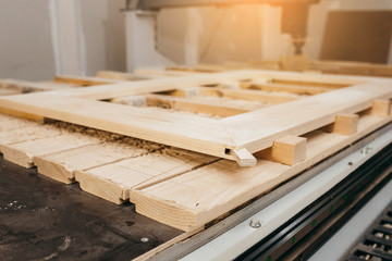 Close-up of cutting wood on a CNC milling machine in garage