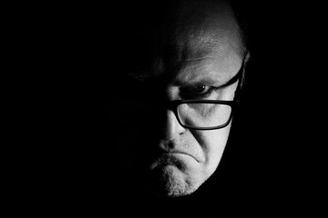 portrait of a man with glasses, half face, photograph monochrome