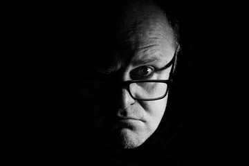 portrait of a man with glasses, half face, photograph monochrome
