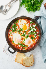 Shakshouka, eggs poached in sauce of tomatoes, olive oil. Mediterranean cousine.