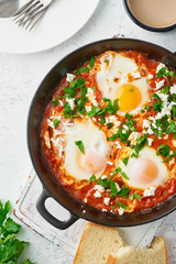Shakshouka, eggs poached in sauce of tomatoes, olive oil. Mediterranean cousine.