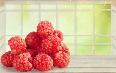 Ripe red fresh raspberries on the desk