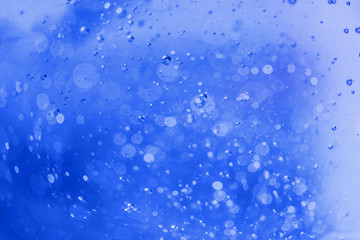 Lot of small bubbles on an blue background, macro shot of liquid soap, macro shot of glass with beer, macro shot of cocktail with fruit juice