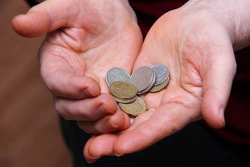 Russian coins in the hands of an elderly man. Close-up, selective focus.