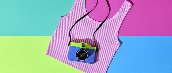 Fashion film camera. Minimal hipster summer trend flat lay. Retro design camera on vivid color. Summertime concept. Trendy fashionable film camera, creative pop art