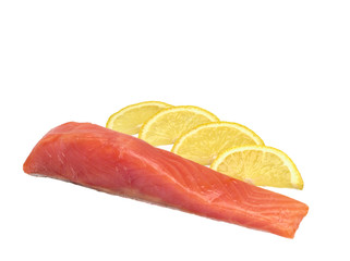A piece of salted salmon with slices of lemon on white background