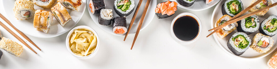 Japanese food. Big sushi set. Assorted set of various sashimi, maki and sushi rolls with different fillings - tuna, sea bass, salmon, shrimp, vegetables. Flatlay copy space