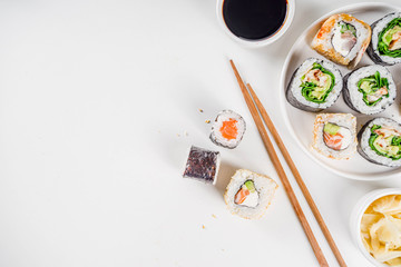 Japanese food. Big sushi set. Assorted set of various sashimi, maki and sushi rolls with different fillings - tuna, sea bass, salmon, shrimp, vegetables. Flatlay copy space © ricka_kinamoto