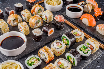 Japanese food. Big sushi set. Assorted set of various sashimi, maki and sushi rolls with different fillings - tuna, sea bass, salmon, shrimp, vegetables. Flatlay copy space