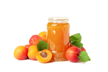 Glass jar with jam and apricots isolated on white background