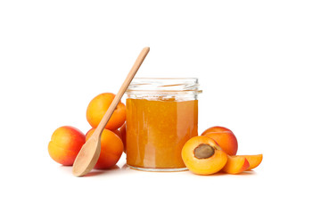 Glass jar with jam and apricots isolated on white background