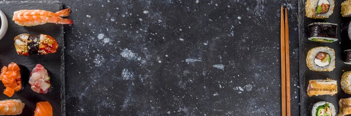 Japanese food. Big sushi set. Assorted set of various sashimi, maki and sushi rolls with different fillings - tuna, sea bass, salmon, shrimp, vegetables. Flatlay copy space © ricka_kinamoto