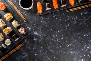 Japanese food. Big sushi set. Assorted set of various sashimi, maki and sushi rolls with different fillings - tuna, sea bass, salmon, shrimp, vegetables. Flatlay copy space © ricka_kinamoto