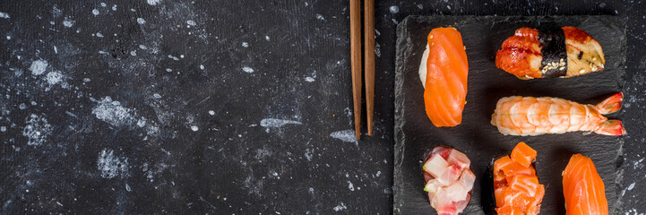 Japanese food. Big sushi set. Assorted set of various sashimi, maki and sushi rolls with different fillings - tuna, sea bass, salmon, shrimp, vegetables. Flatlay copy space © ricka_kinamoto