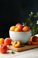 Composition with tasty apricots on wooden table against dark background